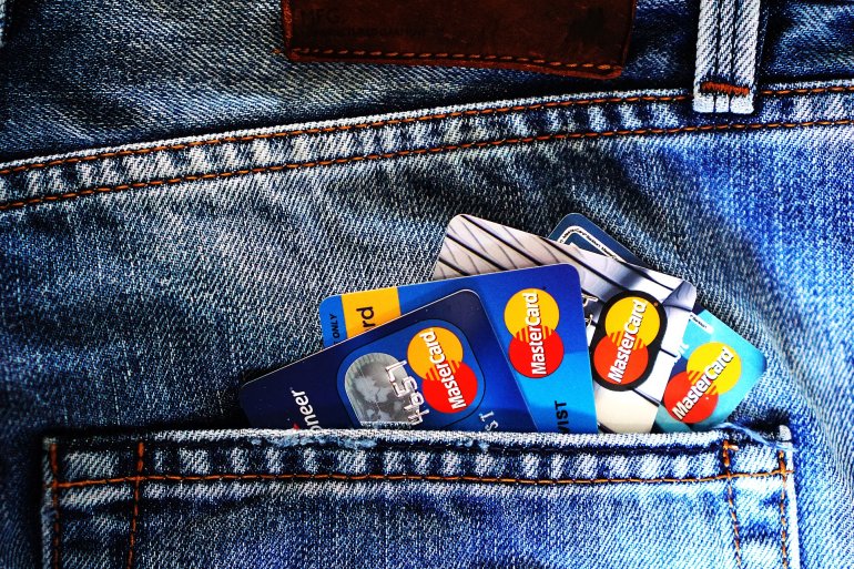 Кредитки различных банков в заднем кармане джинс