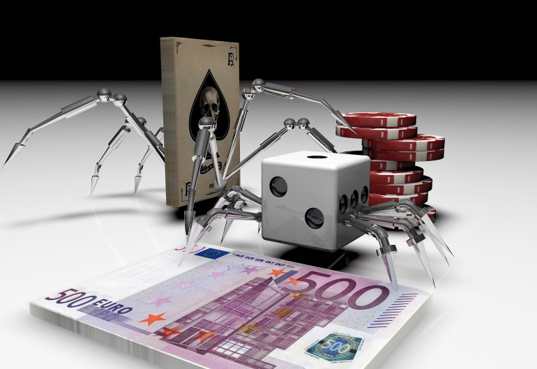 Колода карт и кости с паучьими железными лапами рядом с фишками и пачкой денег номиналом 500 евро