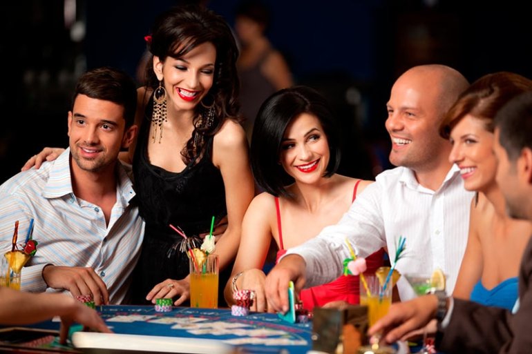 Компания молодых эллегантных людей за игрой в казино